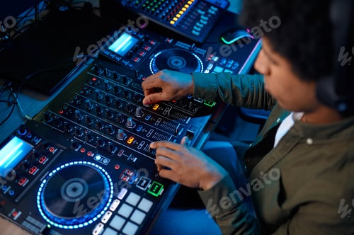 Preview: Portrait of radio host using sound mixer in studio