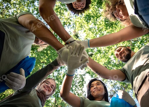 Preview: Portrait of multiethnic group of volunteers with garbage bags cleaning city park.
