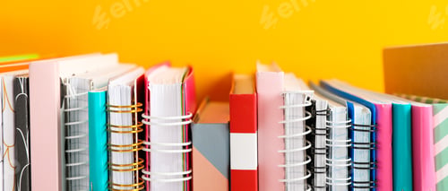 Preview: Stack of colorful books against background, space for text