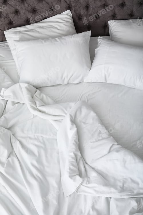 Preview: Soft white pillows on comfortable bed, closeup