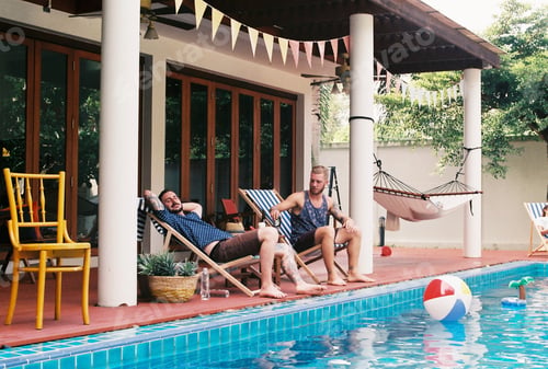 Preview: People sitting by the pool enjoying summer time