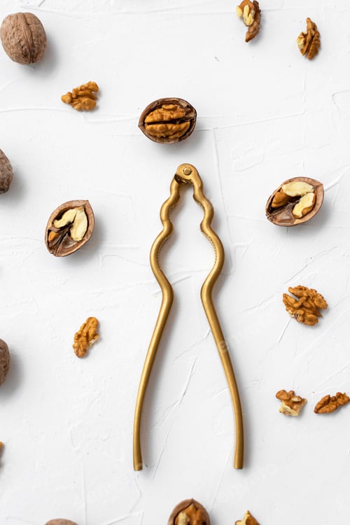 Preview: Walnut with nutcracker on white background