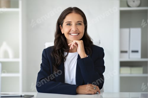 Preview: Portrait of beautiful mature lady posing at office