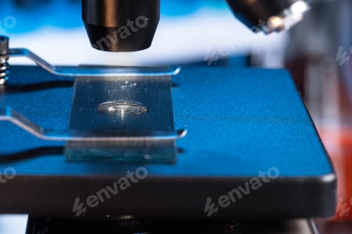 Preview: Microscope with lenses close up against dark background