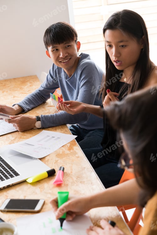 Preview: Three Asian people discussing project