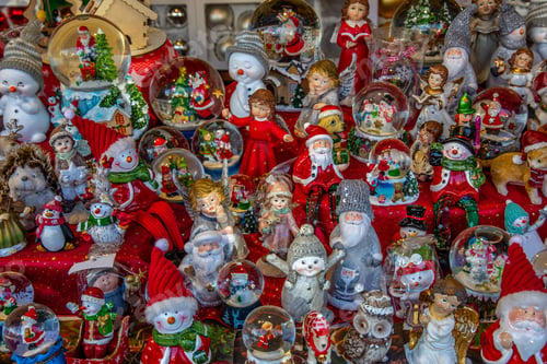 Preview: Closeup shot of varieties of tiny Christmas figures displayed in a market stand