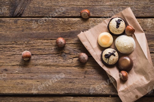 Preview: Chocolate pralines on old wooden table. Food
