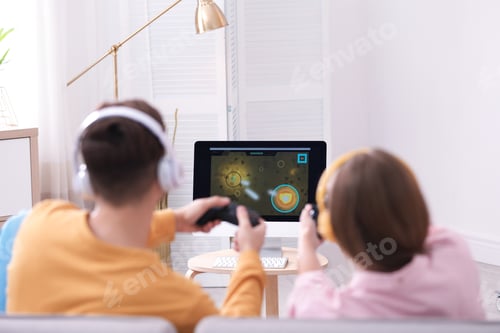 Preview: Young couple playing video games at home