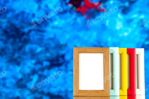 Preview: front view different picture frames with colored corners on a blue background color picture shoot