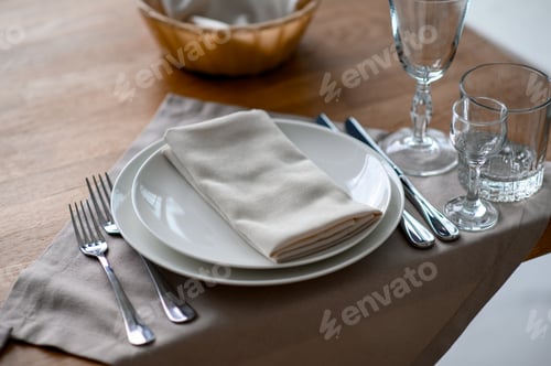 Preview: Festive romantic table setting with silverware, gray napkin and white crockery