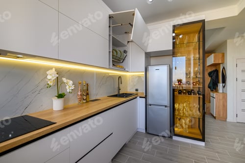 A contemporary white studio with a functional kitchen
