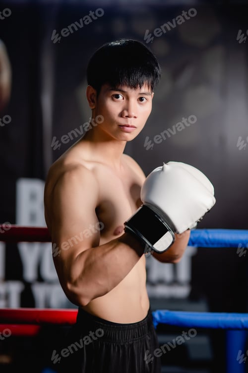 Preview: Young man shirtless pose in boxing gloves at fitness gym