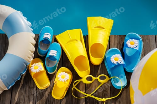 Preview: Beach flip-flops and sunglasses on wooden planks near swimming pool