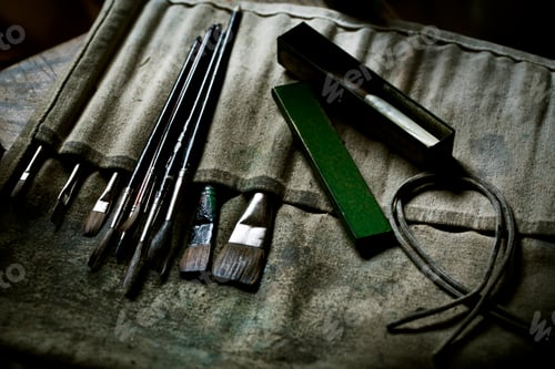 Preview: A row of paint brushes and hand tools.