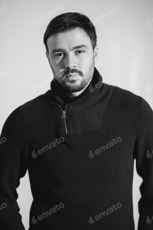 Preview: Grayscale shot of a young Caucasian male with a serious face wearing a turtleneck shirt