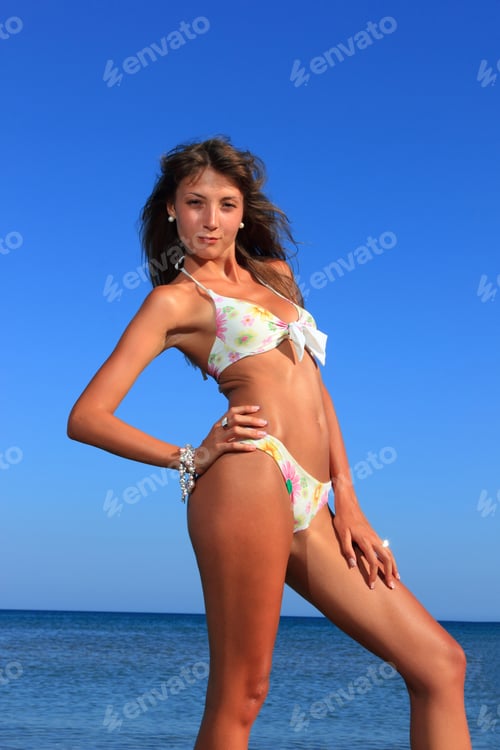 Preview: beautiful model relaxing on a beach