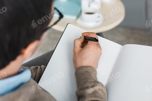Preview: Close-up view of psychotherapist making notes of patient complaints