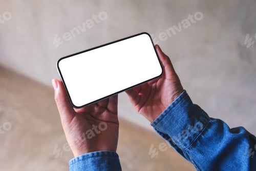 Preview: Top view mockup image of a woman holding mobile phone with blank desktop screen