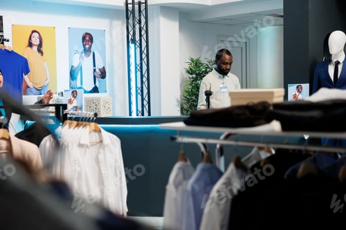 Preview: Clothing store cashier at counter desk