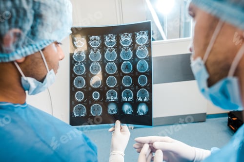 Preview: back view of doctors in uniforms and medical masks looking at x-ray