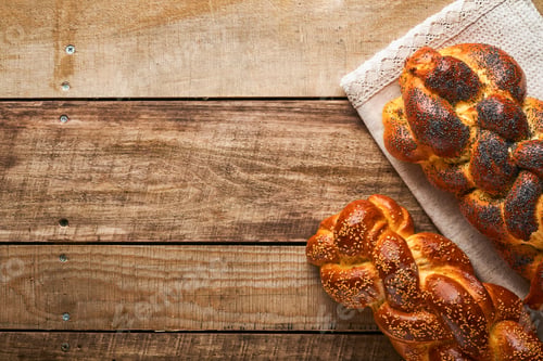 Preview: Shabbat Shalom. Bread challah with sesame seeds and poppy seeds on wooden background. Traditional je