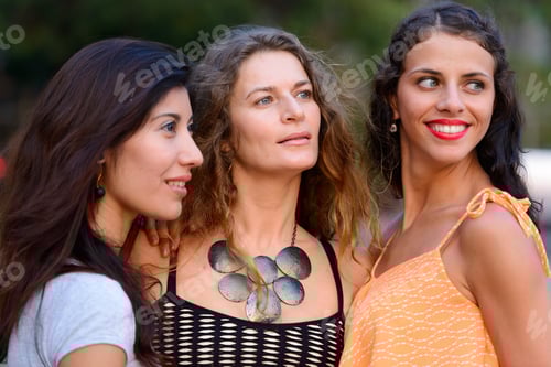 Preview: Three young beautiful women as friends together outdoors