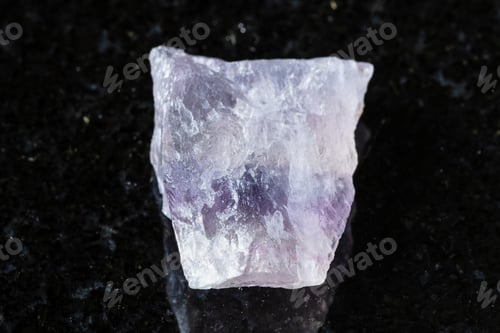 Preview: uncut purple striped fluorite mineral on black