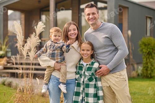Preview: Man woman with child and girl looking at camera