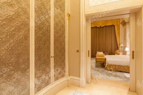 Preview: Luxury wardrobe room with a glimpse of the bedroom. Luxury life in Abu Dhabi, UAE.