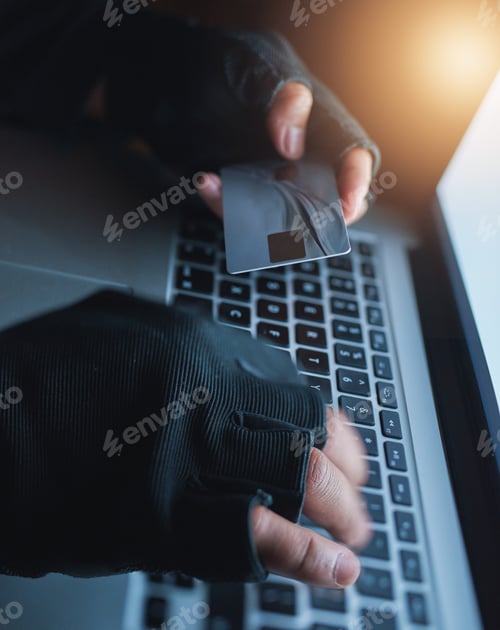 Preview: Shot of an unrecognisable hacker using a laptop to hack into a credit account