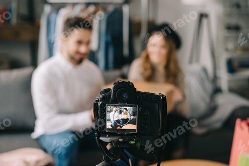 Preview: Man and Woman in Background of Camera Recording