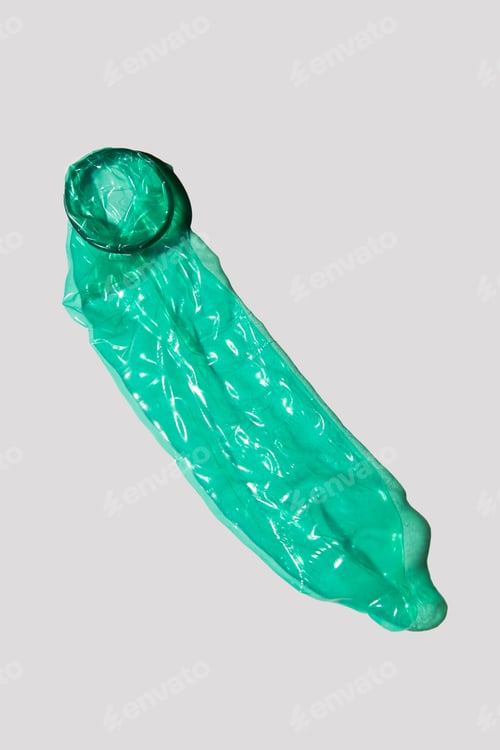 Preview: A printed used green condom.Contraceptive condoms. Latex for sperm and pregnancy protection.