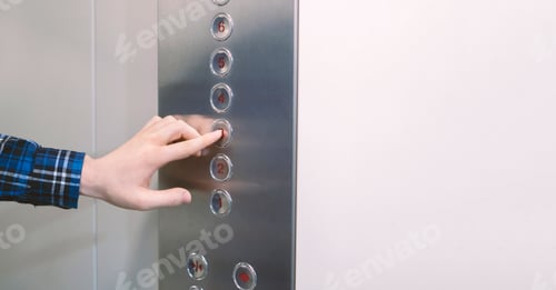 Preview: close up hand pushing a button in the lift elevator cabin