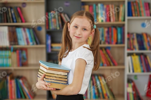 Preview: Child buys books in bookstore for learning or reading. Girl choosing book in school library.