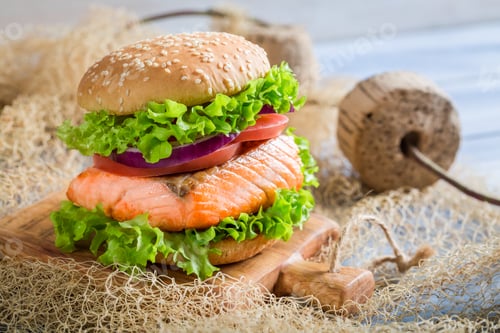 Preview: Tasty fishburger with salmon on old wooden table