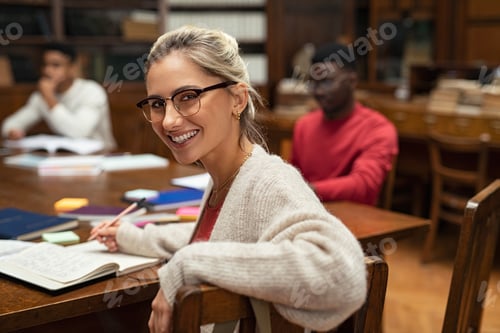 Preview: Happy female student in library