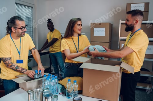 Preview: Group of multiracial volunteers working in community charity donation center