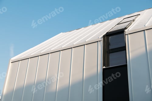 Preview: Metal hangar against the blue sky in winter snow day