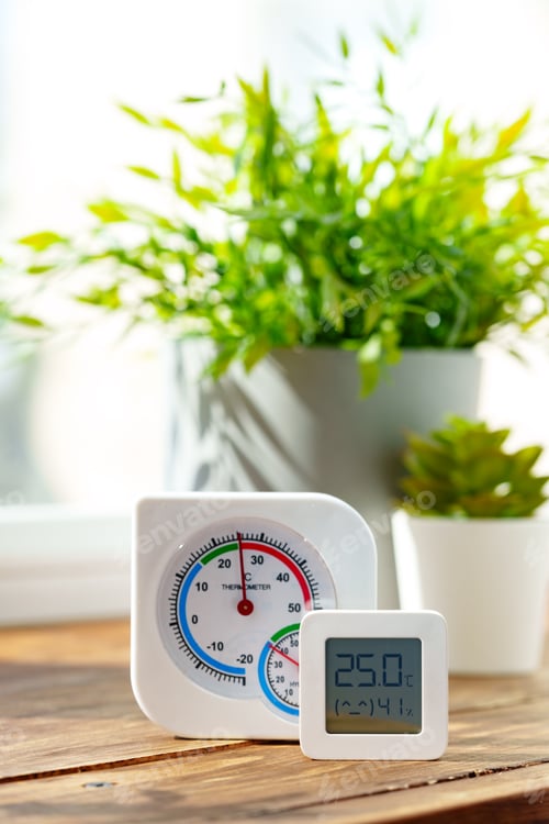 Preview: Digital Thermometer Displaying Temperature and Humidity Near Window