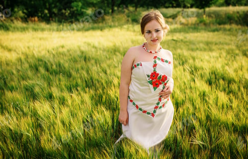 Preview: Young girl at ukrainian national dress posed at wreath field.