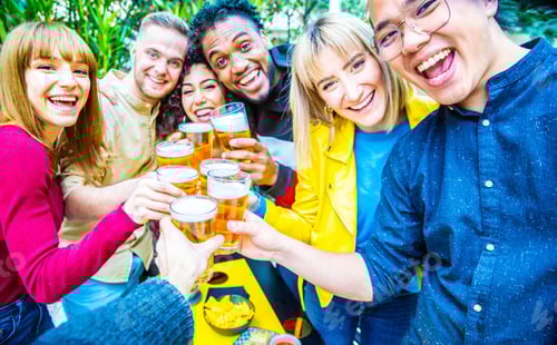 Preview: Group of multicultural friends drinking and toasting beer at brewery bar restaurant