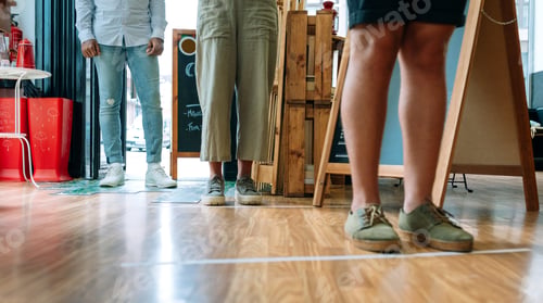 Preview: Unrecognizable people queuing up keeping social distance