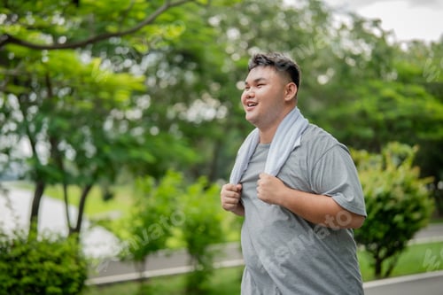 Preview: Asian plus-size man exercises outdoors in the garden to lose weight.