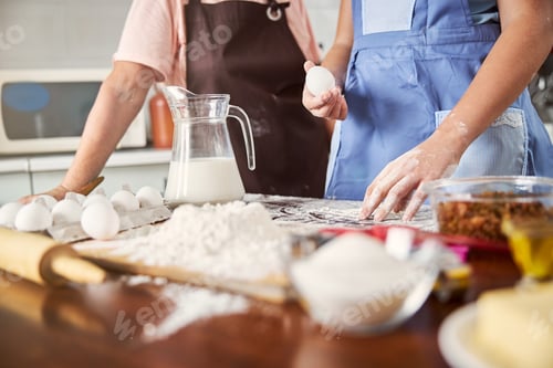Preview: Two people involved in baking process in the kitchen