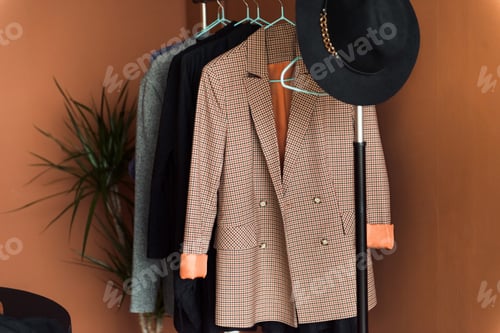Preview: Stylish Coats and a Hat on Hangers