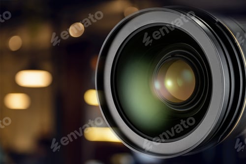 Preview: Professional DSLR camera lens close-up with warm bokeh background.