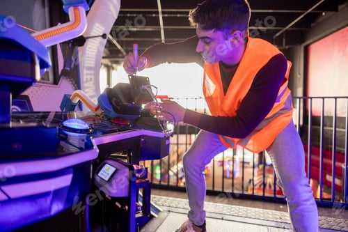 Preview: Technician Repairing Arcade Machine with Precision Tools