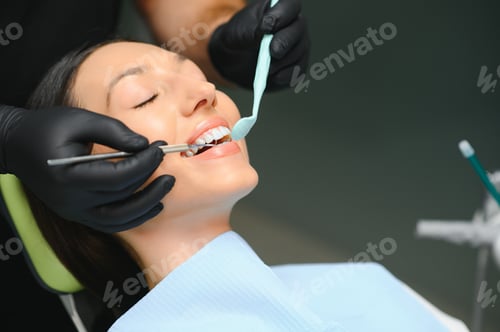 Preview: Dentist examining patient's teeth, close up