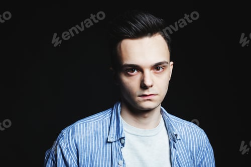 Preview: Young man face portrait in low key.