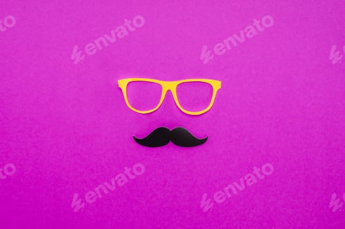 Preview: top view of gentleman face made of cardboard eyeglasses and mustache on pink surface